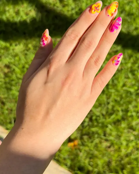 Unhas com flores amarelas e rosas